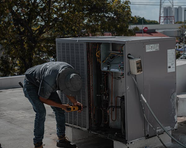 HVAC technician servicing an outdoor unit